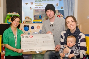 Family being presented with prize cheque